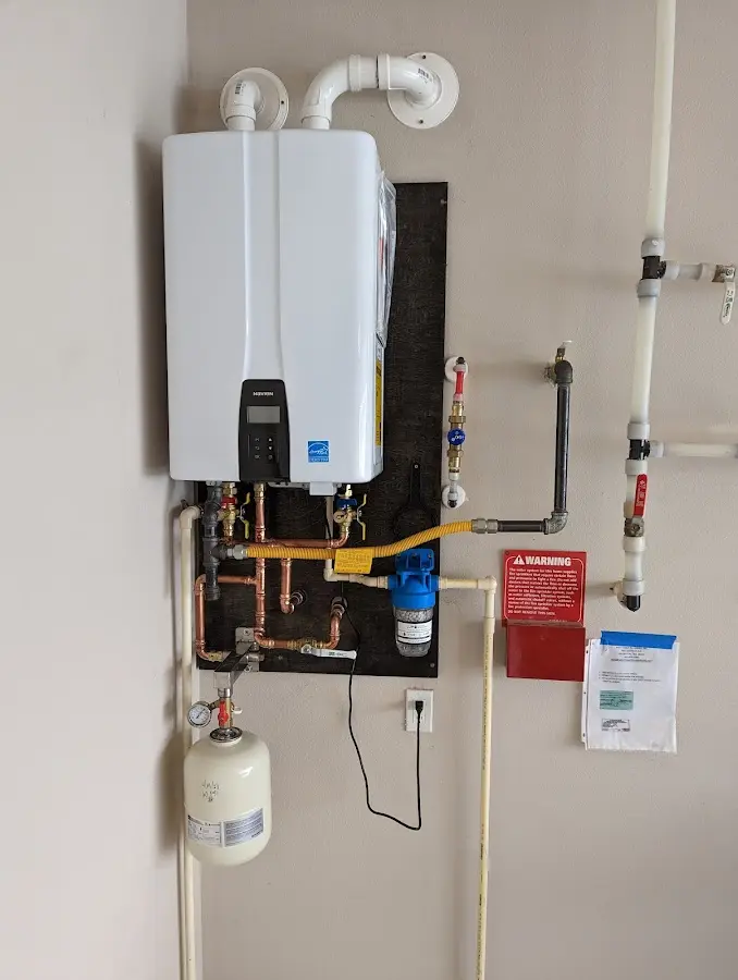 Professional plumber installing copper piping in a Huntington home